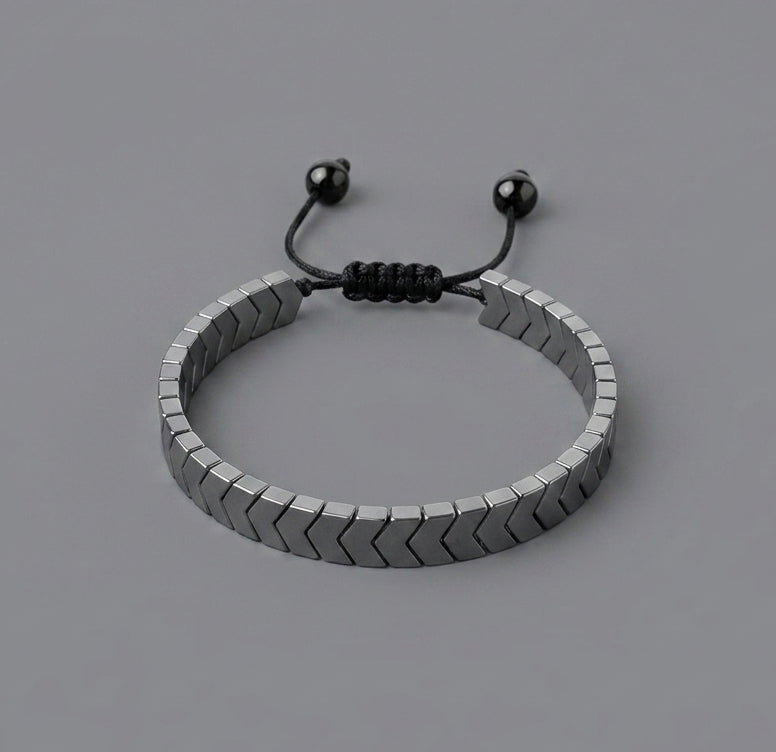 Bracelet with metal arrows linked on a grey background