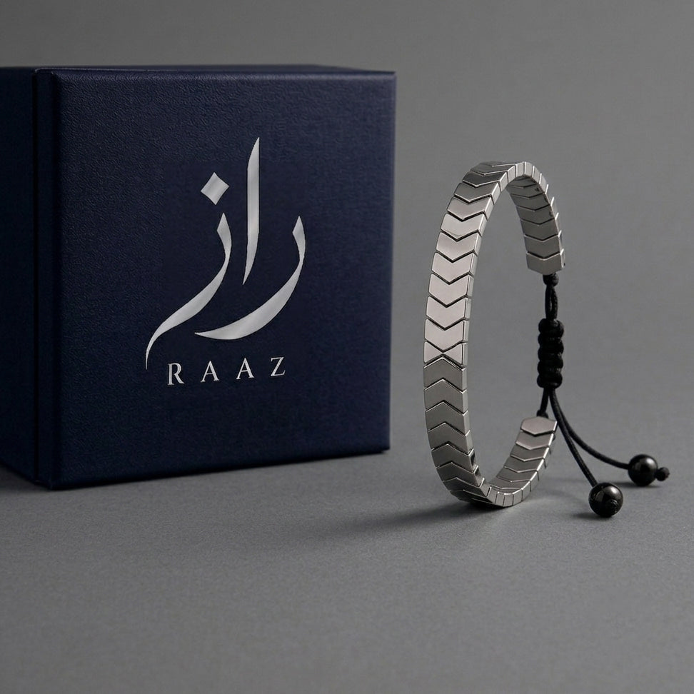 Silver bracelet with RAAZ packaging on a gray background